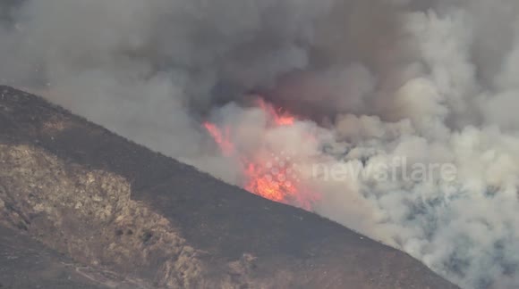 Wildfire season: Flames burn up brush and mountain side