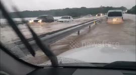 Cars struggle through flooded road in the Philippines