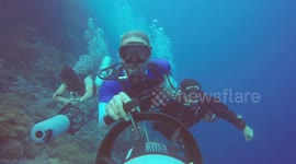 Divers scootering for fun in Red Sea