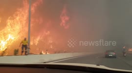 Terrifying moment motorist drives through wildfire near Athens