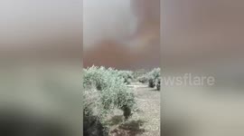 Thick grey smoke envelops mountains near resort town of Kineta