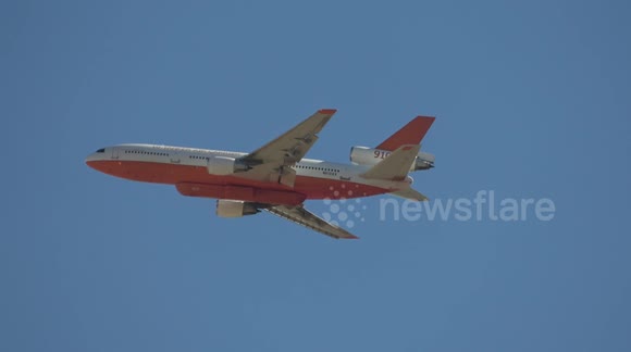 DC-10 Air Tanker 910 firefighting plane flies over San Bernadino during wildfires