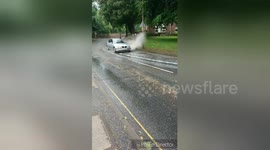 Man deliberately gets a soaking by passing cars to cool off