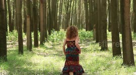 the girl runs through the woods