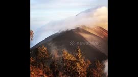 Smoking volcano Fuego in Guatemala with sunset