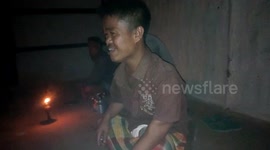 A small man discussion during a drinking party in a village.