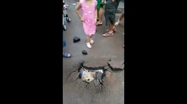 Heavy rain in southwest China cracks road, revealing pumpkin wedged beneath