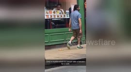 Man walks a banana down the street
