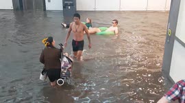 Commuters wade and float through flooded Swedish station