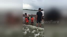 Children play on flooded highway in Vietnam