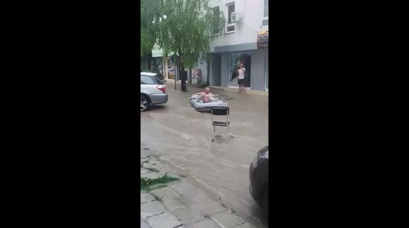 Summer rain in Bulgaria sees people take to the streets in dinghies