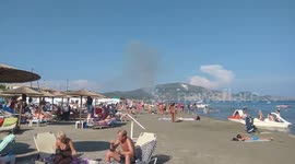 Wildfire burning in distance doesn’t ruin day for beachgoers on Greek island