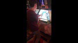 Guys using arcade machines in Japan