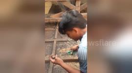 Indonesian family repair damaged home after deadly earthquake