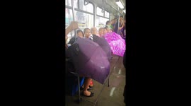Passengers use umbrellas on leaky train in Philippines after monsoon