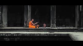 PRAYING CHILD BLESSED BY MONK IN ANCIENT ANGKOR WAT TEMPLE