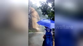 Water cascades down mountainside during Philippines floods