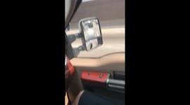 Man rides on back of big rig on 60 freeway