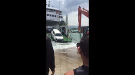 Car falls into water during stormy conditions unloading from ferry