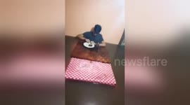 Teenager eats his breakfast in 3 feet of water during Philippines floods