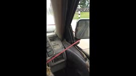 Hilarious moment two lads use ROPE to operated their broken windscreen wipers in heavy rain