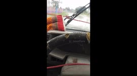 Hilarious moment men use rope to operate broken windscreen wipers in heavy rain