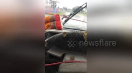 Newsflare Edit - Hilarious moment men use rope to operate broken windscreen wipers in heavy rain
