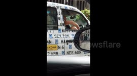 Black cab driver trims his leg hair at London taxi rank