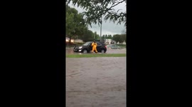 Firefighter rescues driver as fast-moving floodwaters carry vehicle away