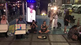 Begpackers seen busking with ukulele in Bangkok
