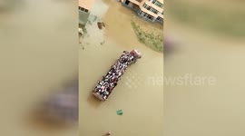 Lorry carries students across flooded campus to station