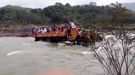 Truck carries dozens of villagers through swollen river after heavy rain