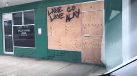 Honolulu resident leaves message for Hurricane Lane on boarded-up storefront