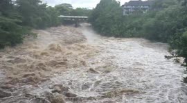 Flood waters rage in Wailuku River of Hilo, Hawaii as residents brace for hurricane