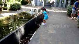 My little girl enjoys throwing stone at the fountain.