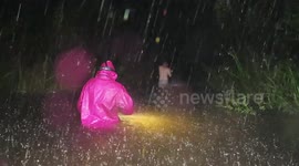 Hawaii locals walk home in waist-deep floodwaters and pouring rain as Hurricane Lane closes in