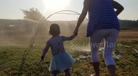 Joyous moment grandma runs through sprinkler with granddaughter will make you go 'awww'