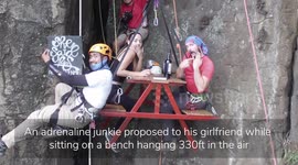 CAPTIONS: Stunning drone footage shows an adrenaline junkie proposing to his girlfriend while sitting on a bench suspended 330ft in the air
