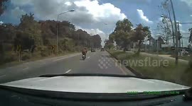 Crazed motorcyclist hits driver's car with a meat cleaver