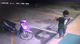 Motorcyclist takes off his shoes to enter shop... has them nabbed by driver outside