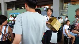 Airport personnel distribute bottled water to travelers stranded on Kansai Airport island