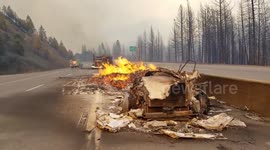 Video shows remains of vehicle debris burning on side of interstate as Delta Fire spreads