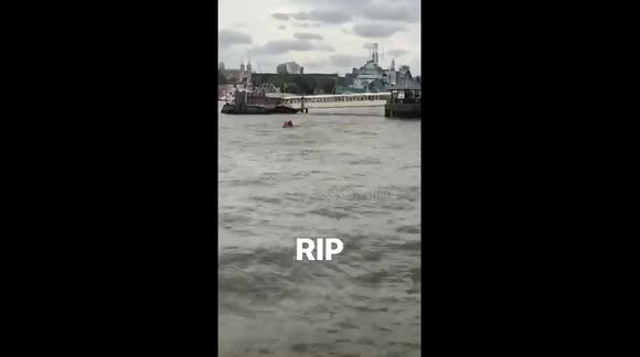 Guys on a small boat on the Thames