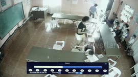 CCTV - Schoolboy puts plastic chair on his back like a rucksack