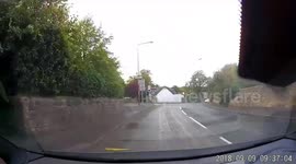Cyclist falls off bike at side of the road, friends all stop and look at him