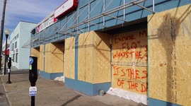N. Carolina Coast: Store windows boarded up along main street