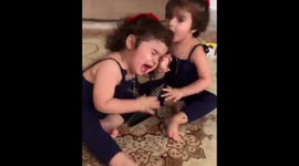 toddlers fighting each other over a cd box