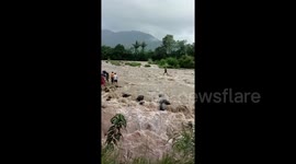Nail-biting moment fisherman is rescued from middle of raging rapids