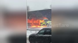 Newsflare Edit - Police car on fire on the M62 after towing stranded wagons in the snow