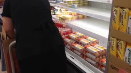 Supermarket worker replenishes shelves as stocks run out ahead of Super Typhoon Mangkhut's landfall in Hong Kong